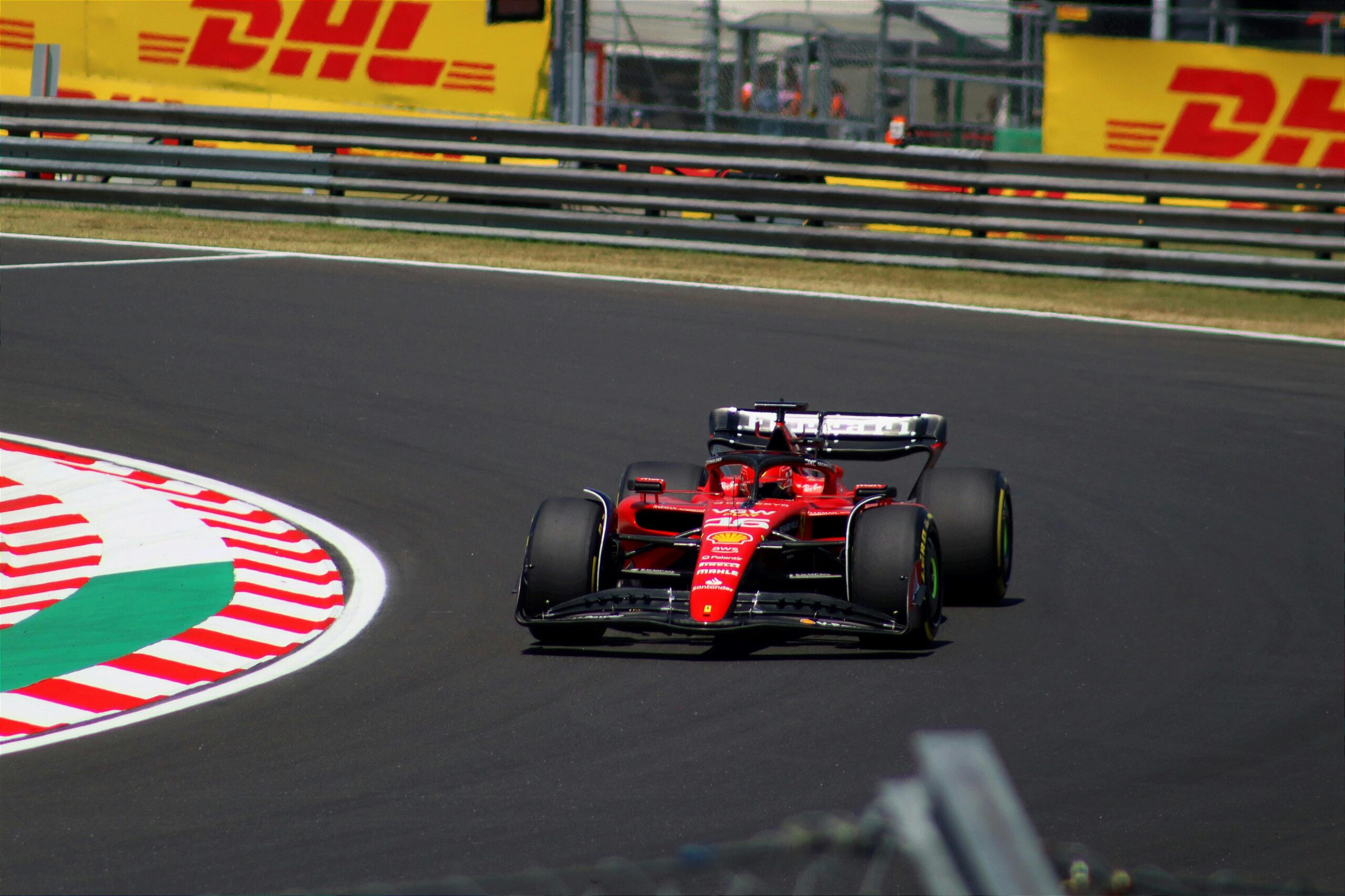 our-services-02 Ferrari F1 car racing at the Hungarian Grand Prix, showcasing thrilling motorsport action.