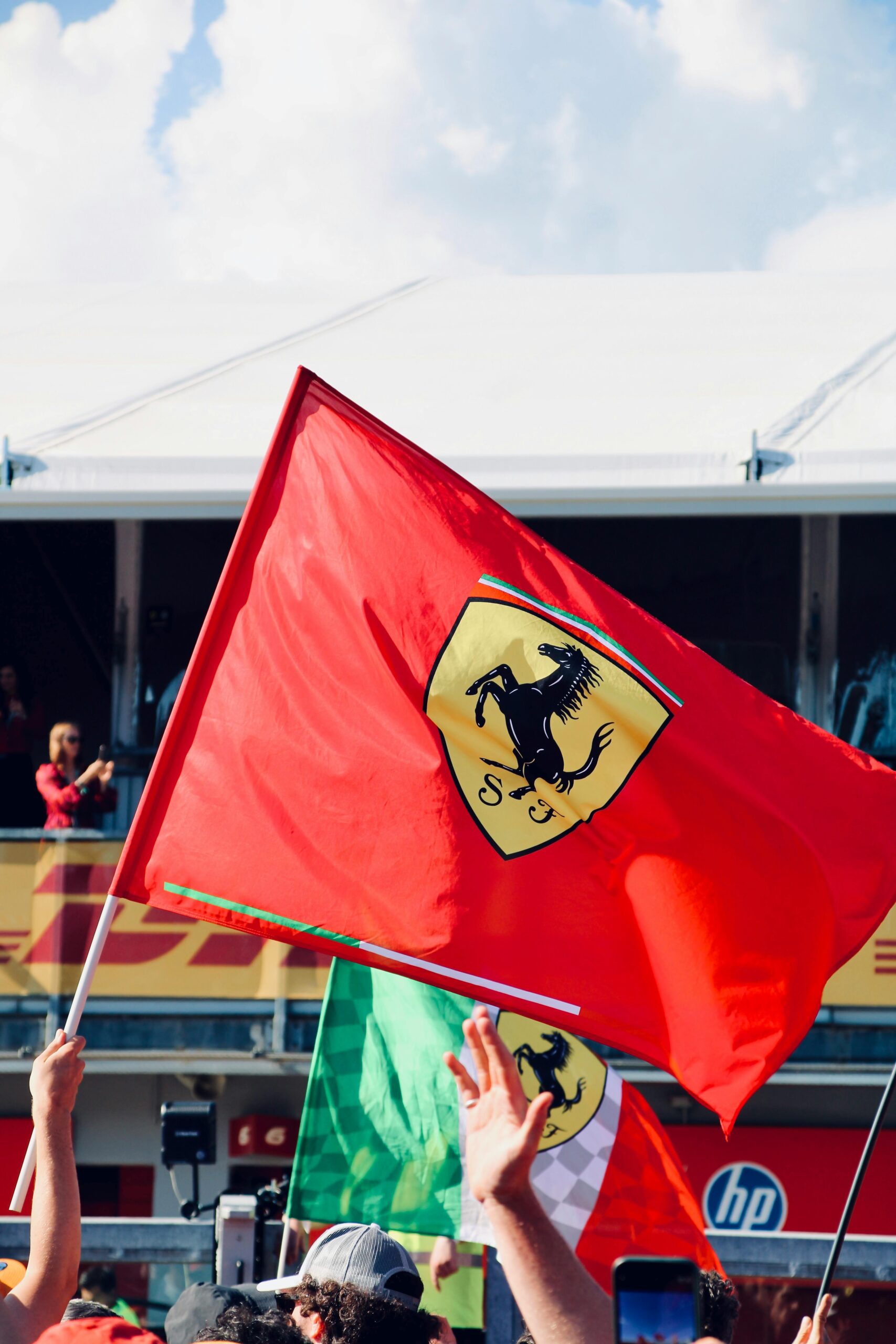 why-choose-us Vibrant scene with Ferrari flag waving during Formula 1 race at Imola, Italy.
